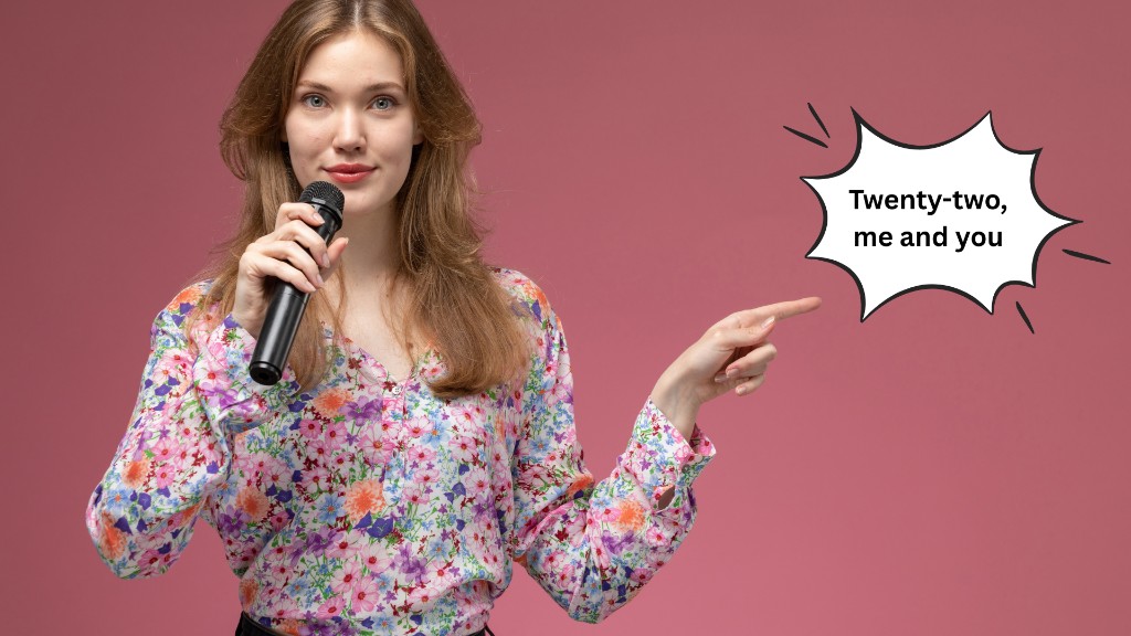 Funny tambola number calls image of cheerful woman with microphone calling “Twenty-two, me and you” with laughing emojis, pink background perfect for tambola two little ducks number 22 kitty party